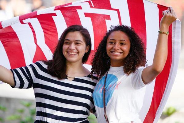 Two female students holding an IU flag.