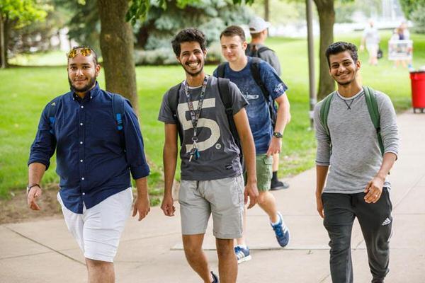 Group of male students walking on IU South Bend campus.