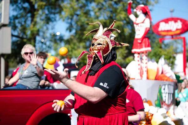 Person with mask walking in a parade.